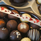 Elegant chocolate truffles in heart-shaped packaging